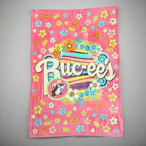 Buc-ee's Flower Blanket has blue, yellow, and orange flowers with a fun pink/peach color. 