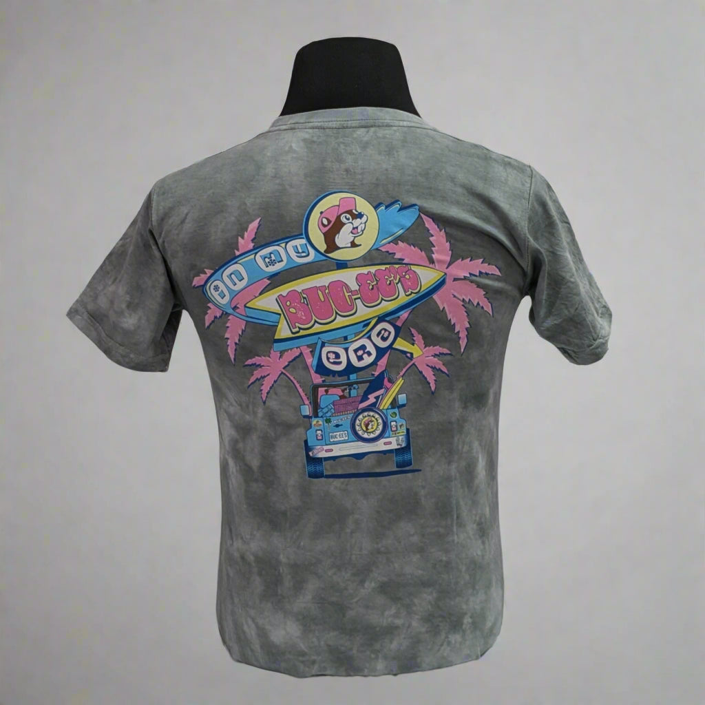 Buc-ee's "In My Era" Shirt. Gray tye die with pink palm trees and "Buc-ee's in My Era" on the back with the truck bed. 