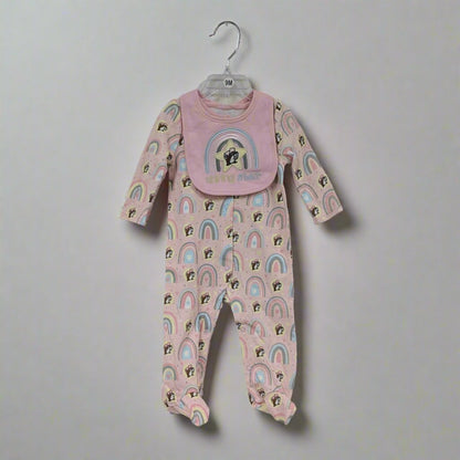 The pink rainbow sleeper with matching bib on a hanger